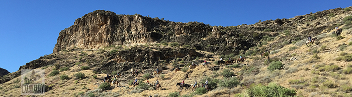 A large group of people riding to the ridge while Horseback Riding in Las Vegas at Cowboy Trail Rides in Red Rock Canyon