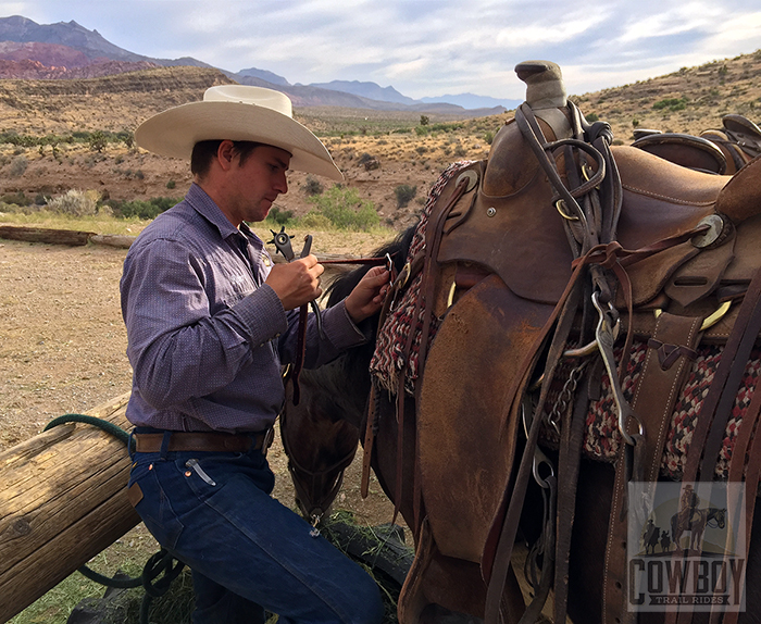 Wrangler Robert fixing gear before a Horseback Riding in Las Vegas at Cowboy Trail Rides in Red Rock Canyon