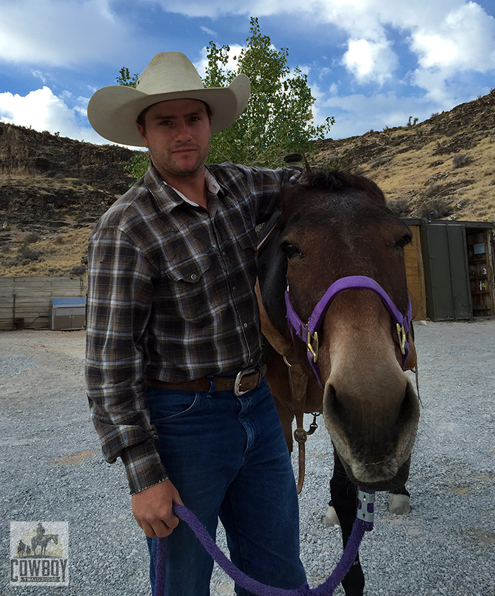 Wrangler Robert gives a much appreciated ear scratch to Gus the Mule before Horseback Riding in Las Vegas at Cowboy Trail Rides in Red Rock Canyon
