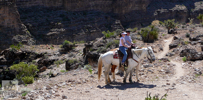 Two riders pose for a picture while Horseback Riding in Las Vegas at Cowboy Trail Rides in Red Rock Canyon